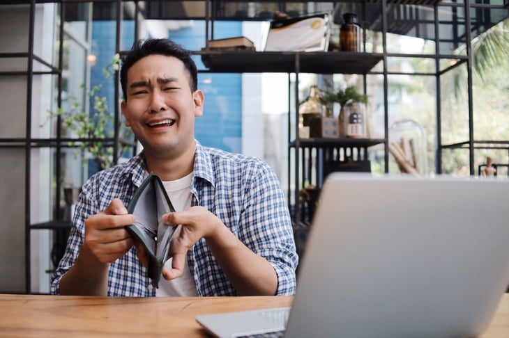 Upset man with empty wallet