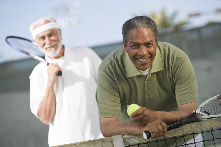 Senior men playing tennis