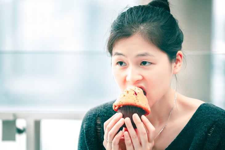 Woman eating a muffin