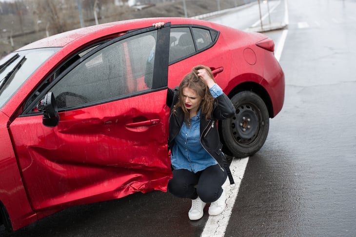 Woman in the rain after a car accident