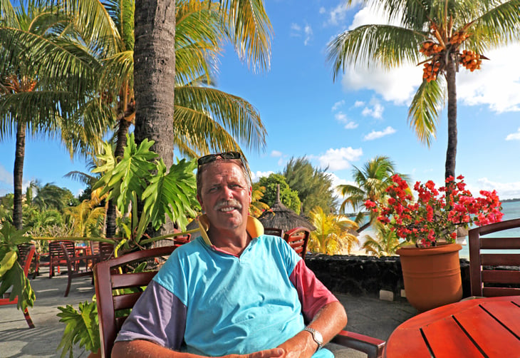 Happy senior retiree living abroad in a tropical area