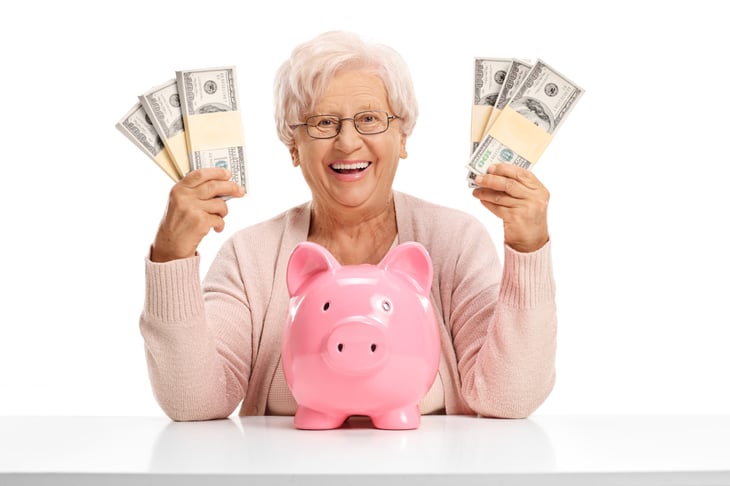 Happy older woman with money.