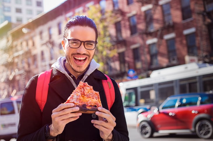 Man eating pizza in New York City