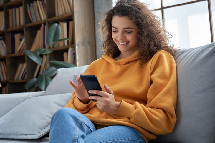 Woman with new phone smiling
