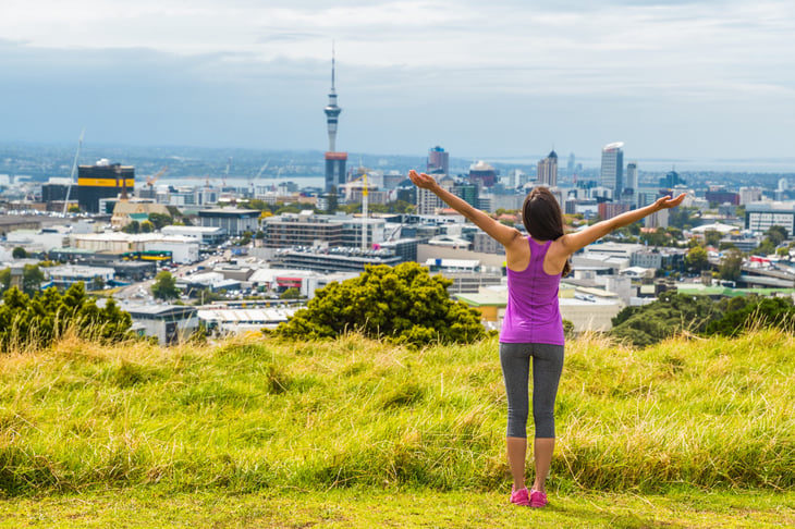 Woman before the Auckland city skyline in New Zealand