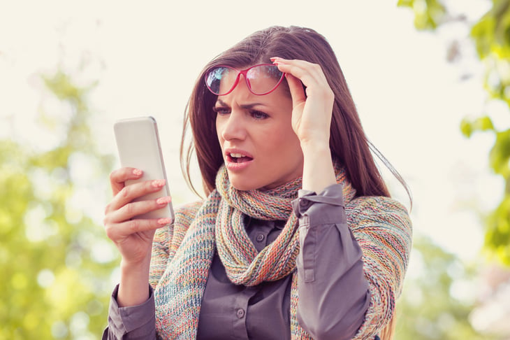 Woman shocked and frustrated by her phone