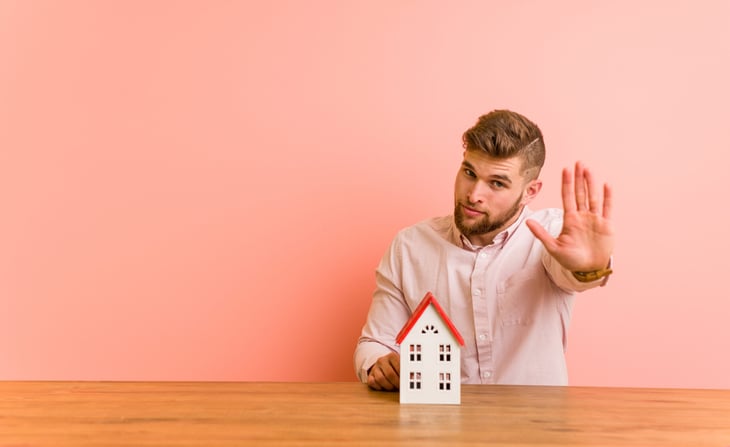 Man holding up his hand to stop a home purchase