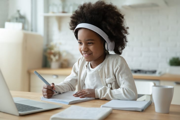 Child working at laptop computer