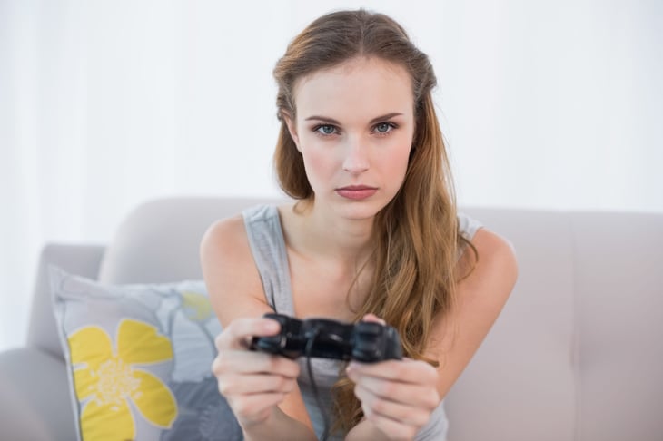 Frowning woman playing video game