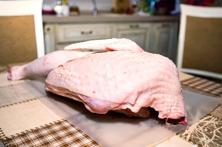 Raw turkey sitting out thawing on the table