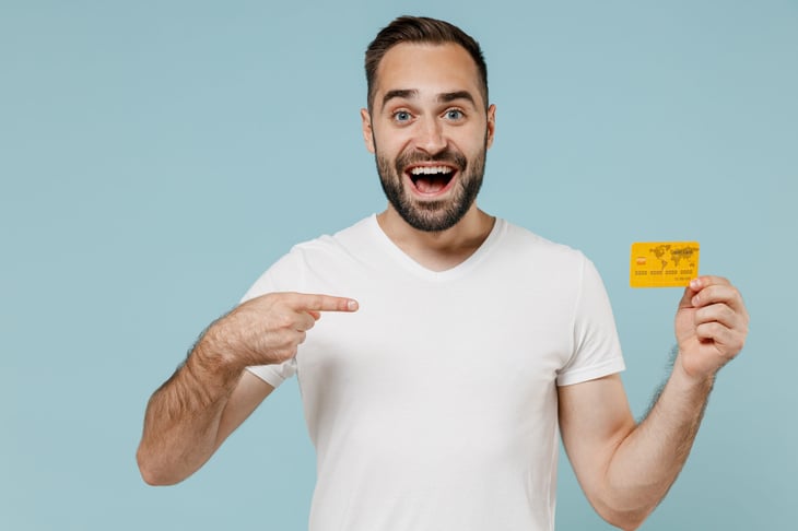 Smiling man with credit card