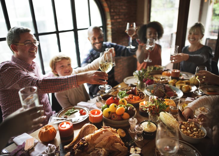 Happy family celebrating Thanksgiving with a toast of wine