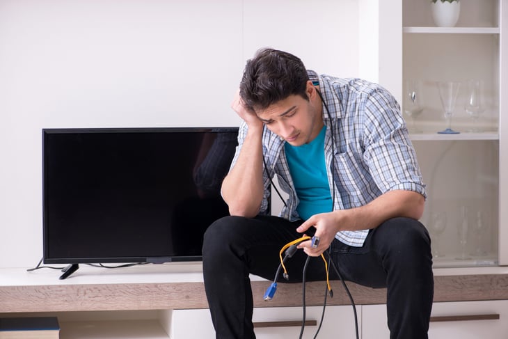 unhappy man with broken TV