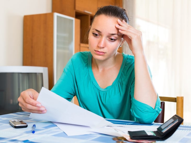 Unhappy woman doing her taxes