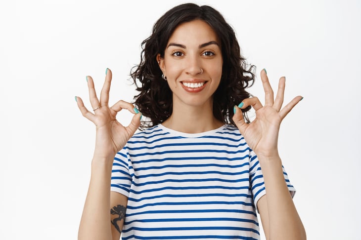 Happy smiling woman giving the OK symbol and satisfied
