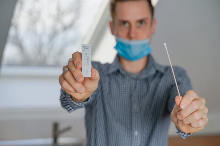 Man taking COVID test at home