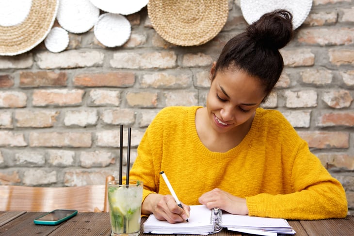 Woman writing in a notebook