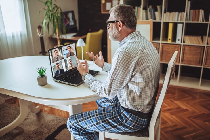 man sits at his laptop in a video call
