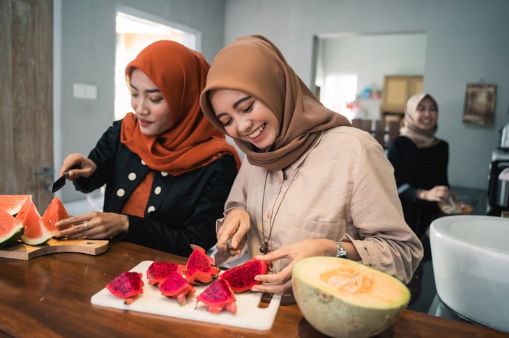 Women cutting fruit