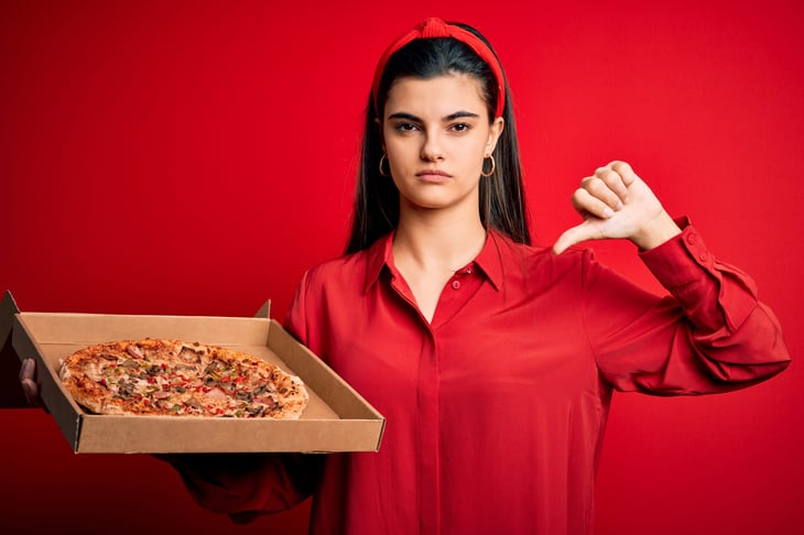 Unhappy woman with pizza
