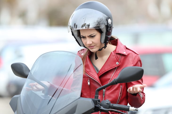 Unhappy woman on a motorcycle