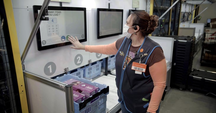 Walmart associate interacting with screen in a market fulfillment