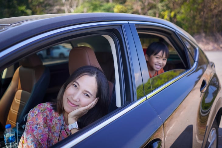 Happy family in black car