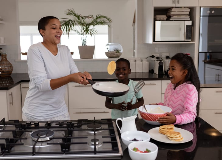 Mother cooking pancakes