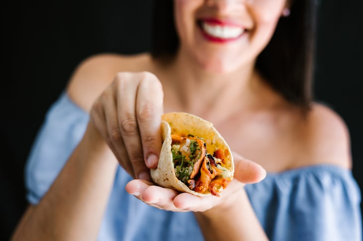 woman holding taco