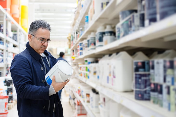 Man shopping for paint at a hardware store