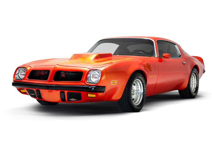 Izmir, Turkey - July 11, 2020: Orange colored Side front view of a 1974 Pontiac Trans Am Brand muscle car on a white background studio shot.