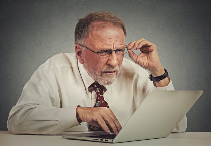 Senior worker unhappy at a computer