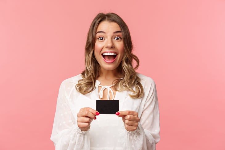 Excited woman with gift card