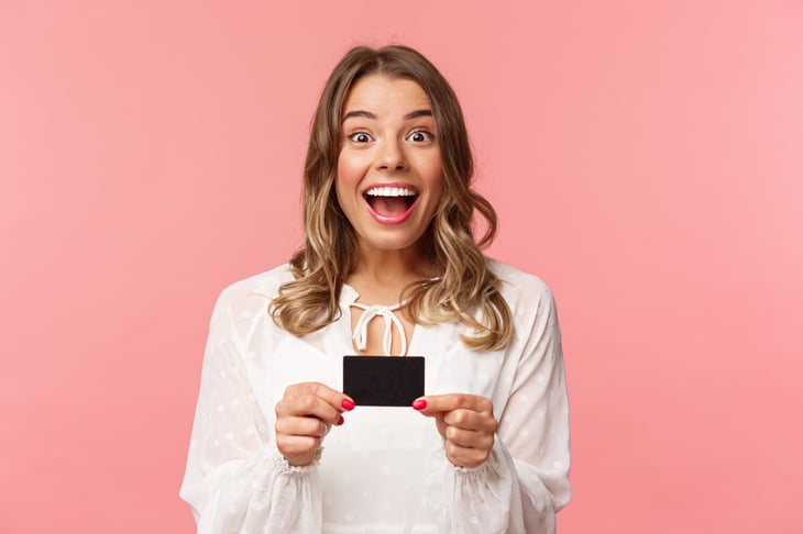Excited woman with gift card