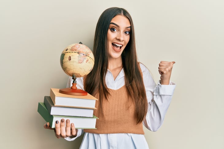 Woman with books and a globe