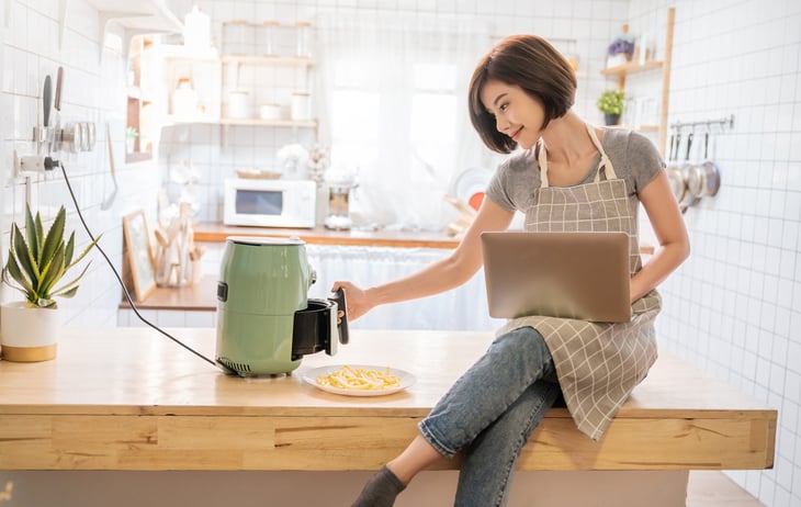 Woman cooking with air fryer