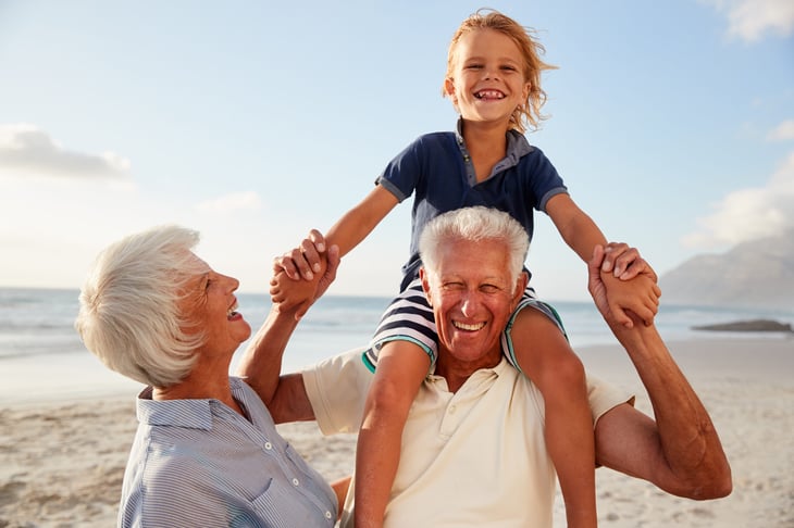 Grandparents with their grandchild on the beach