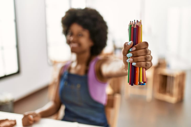 Woman holding colored pencils