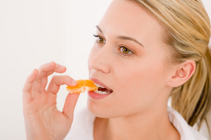 Woman eating a tangerine