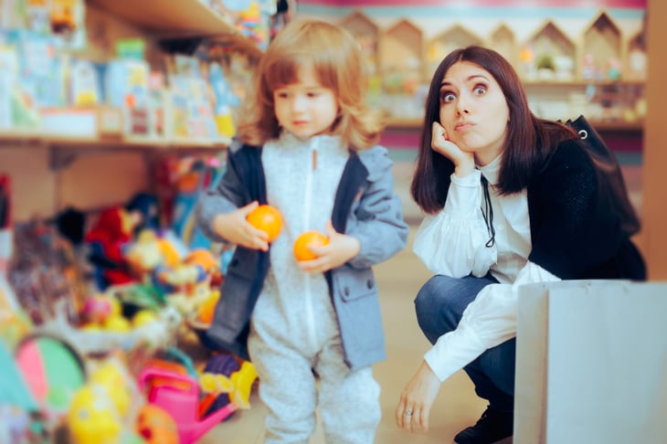 exasperated mom shopping with daughter for toys