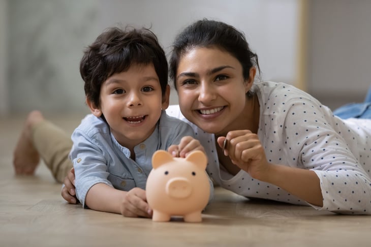 Mother and son with a piggy bank