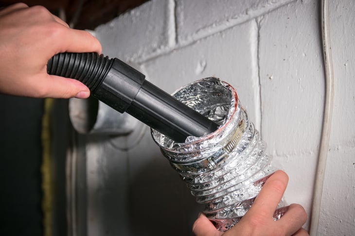 Cleaning dryer hose with a vacuum