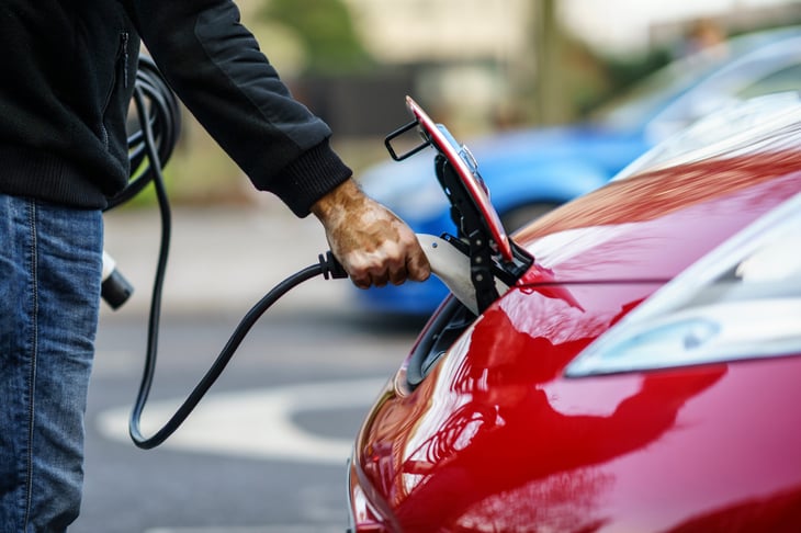 Man charging a Nissan Leaf electric vehicle