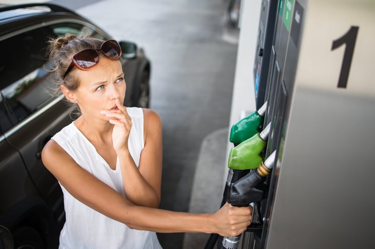 Upset woman at the gas pump