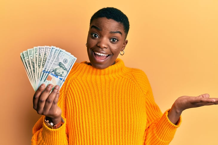 Smiling woman with cash