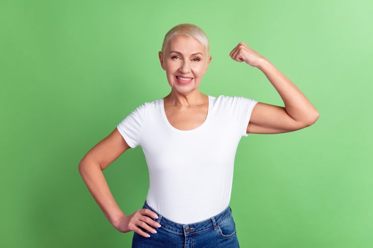 Healthy older woman showing off her arm muscles