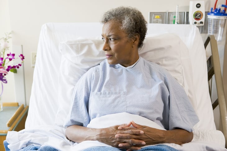 Worried senior woman in a hospital bed