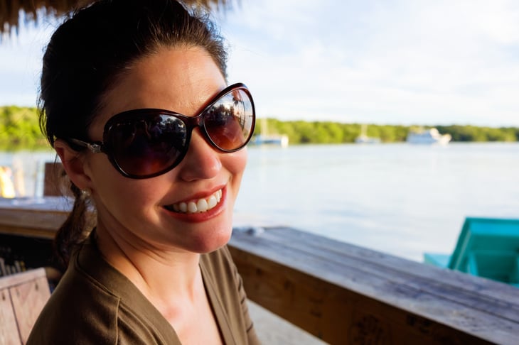 Happy woman in sunglasses by the beach in Florida