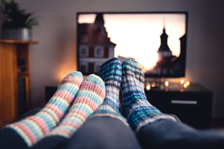 Couple with their feet up watching TV