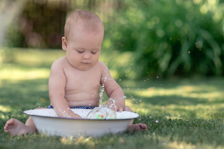 Baby playing with water in bowl